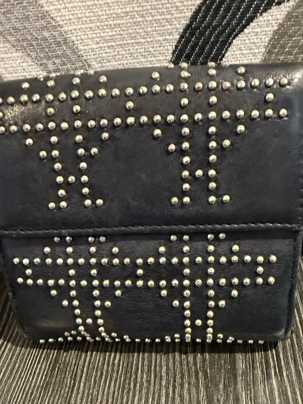 Christian Dior studded black compact wallet.